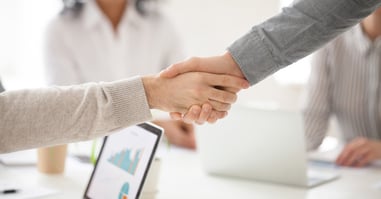 An image of a sales rep closing a deal highlights how commission plans can be a powerful growth strategy.