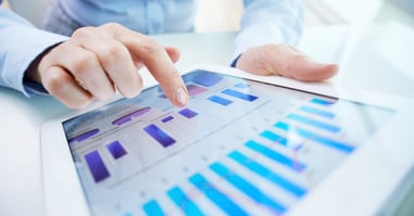 Manager presenting charts to highlight the risks of outdated sales data on the business