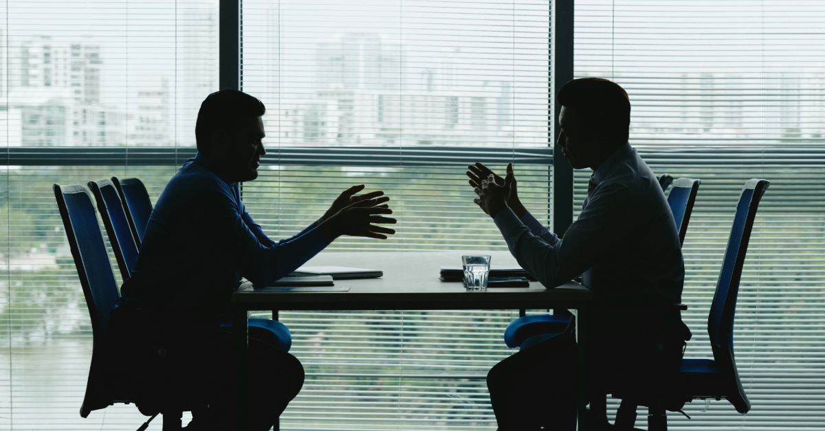 Image of a sales leader and an employee discussing due to the lack of transparency in commission plans.